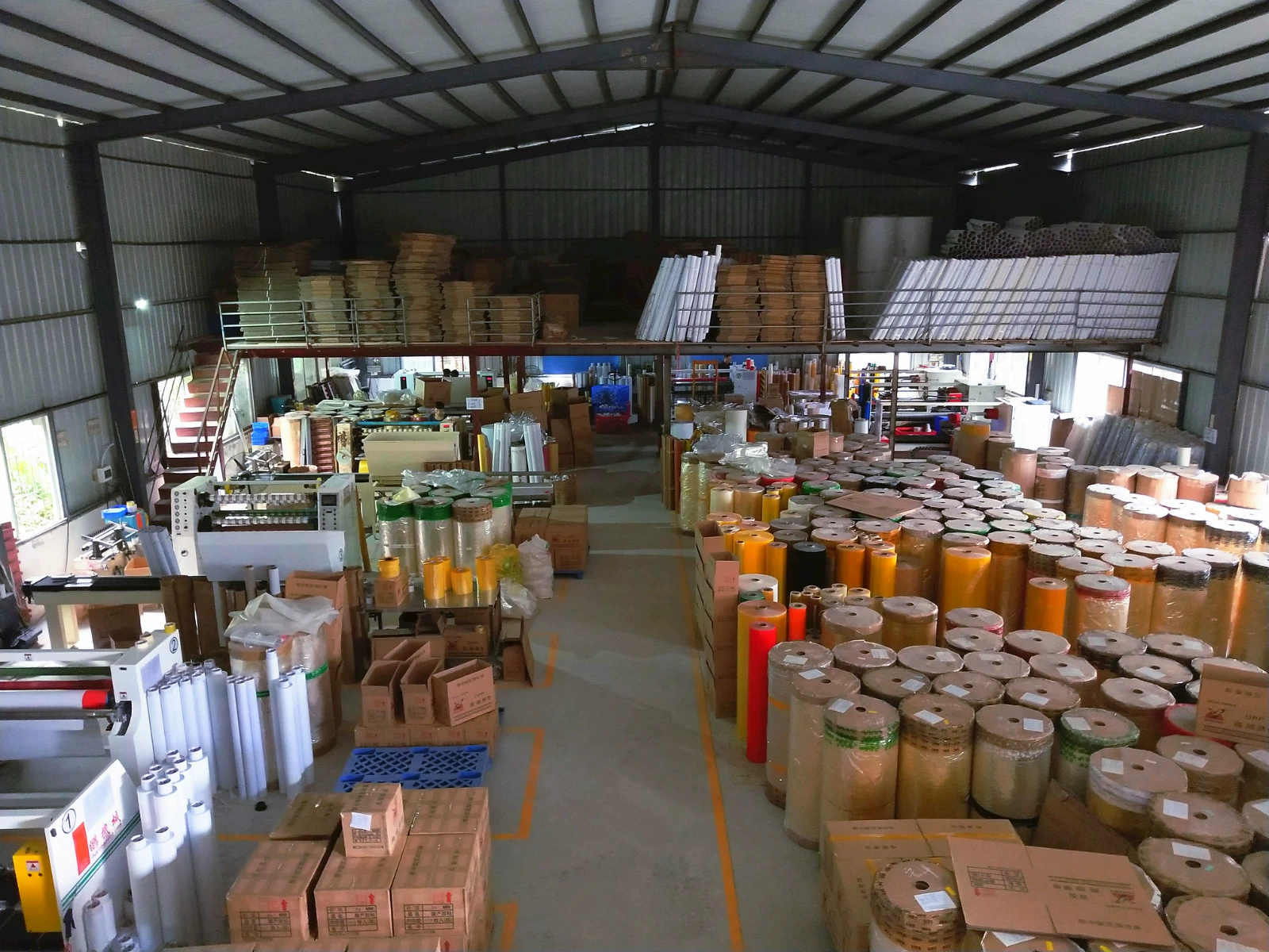 Warehouse interior of Hongyang Tape, showcasing neatly stacked rolls of packaging and adhesive tapes.