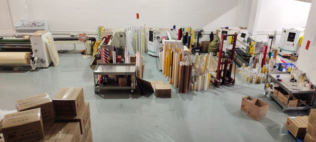 Hongyang Tape's production area with machinery, various tape rolls, and packaged boxes ready for B2B distribution.