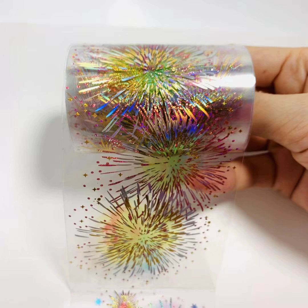 Roll of colorful metallic tape with a hand holding it on a white background